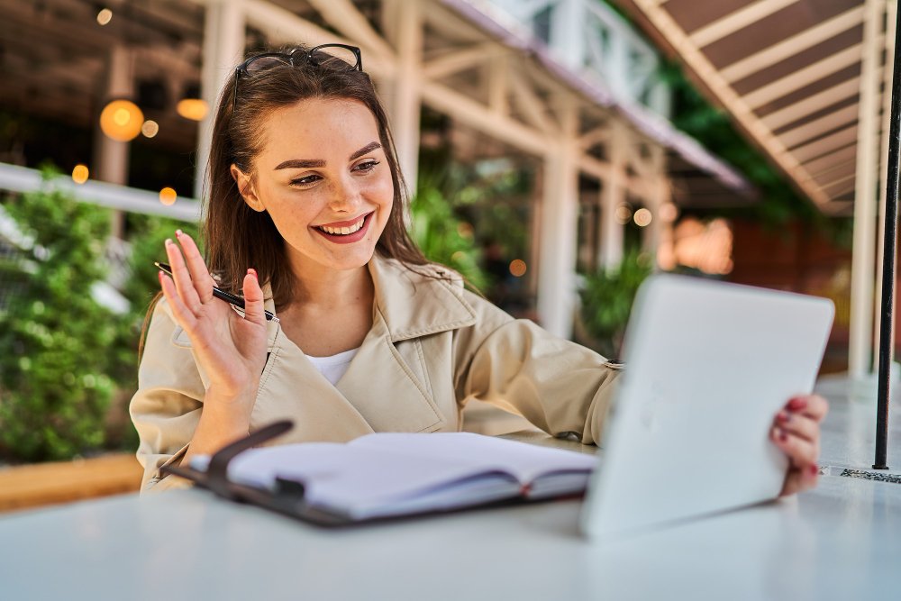 beautiful-woman-speaking-by-video-call-with-tablet-outdoors