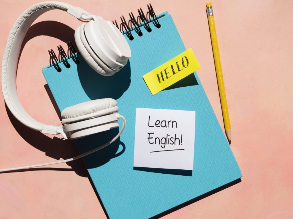 Gírias em inglês que você precisa saber | Foto de um caderno com um post it escrito learn english colado | IP School